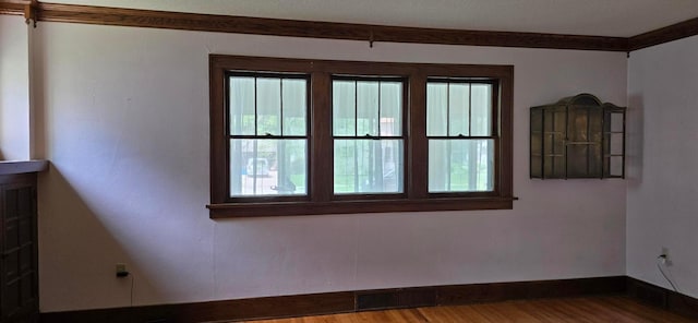 309 5th St SW, Austin, MN 55912 - empty room with wood finished floors and crown molding