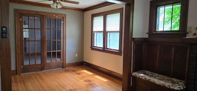 309 5th St SW, Austin, MN 55912 - entryway with light wood-style floors, ceiling fan, and ornamental molding