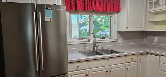 309 5th St SW, Austin, MN 55912 - kitchen featuring freestanding refrigerator, white cabinetry, light countertops, and open shelves