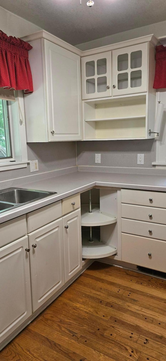 309 5th St SW, Austin, MN 55912 - kitchen with open shelves, white cabinets, light countertops, and dark wood-type flooring