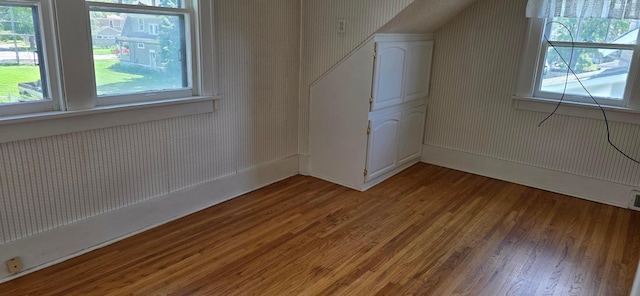 309 5th St SW, Austin, MN 55912 - additional living space with wallpapered walls, light wood-style floors, healthy amount of natural light, and lofted ceiling