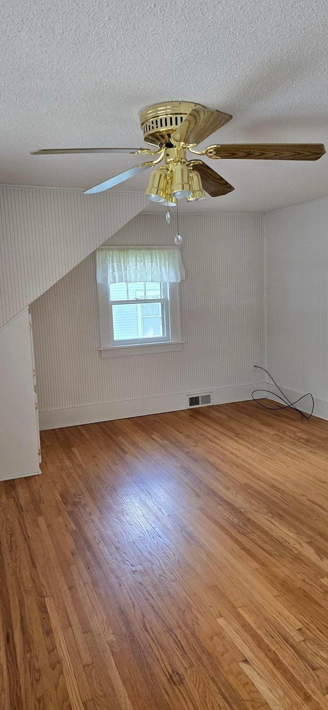 309 5th St SW, Austin, MN 55912 - unfurnished room with wood finished floors, a textured ceiling, and ceiling fan