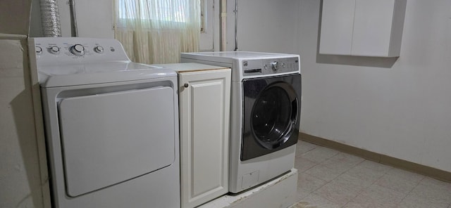 309 5th St SW, Austin, MN 55912 - laundry room with washing machine and dryer, cabinet space, and light flooring