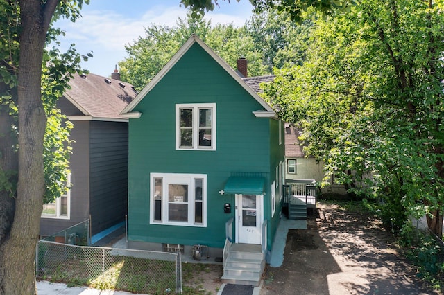 587 Elfelt St, Saint Paul, MN 55103 - view of front of house featuring a chimney, entry steps, and a shingled roof