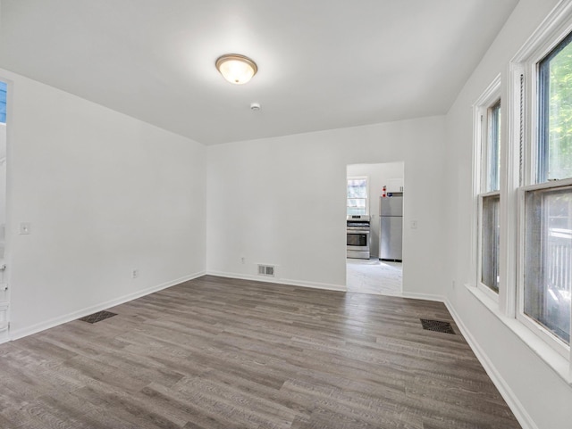 587 Elfelt St, Saint Paul, MN 55103 - empty room with healthy amount of natural light and wood finished floors
