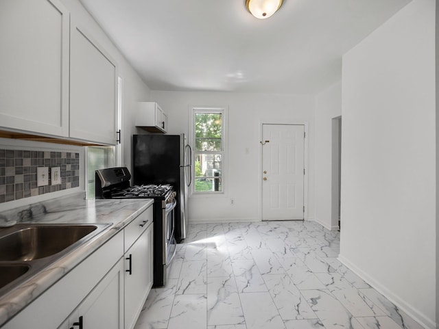 587 Elfelt St, Saint Paul, MN 55103 - kitchen featuring stainless steel range with gas cooktop, light marble finish flooring, white cabinetry, and decorative backsplash