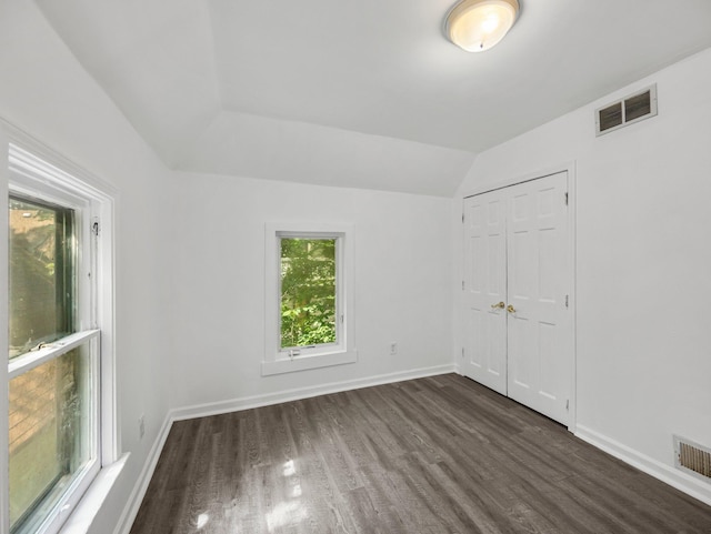 587 Elfelt St, Saint Paul, MN 55103 - unfurnished bedroom with dark wood-type flooring, vaulted ceiling, and a closet