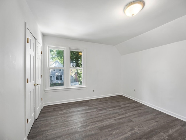 587 Elfelt St, Saint Paul, MN 55103 - unfurnished bedroom featuring dark wood-type flooring, vaulted ceiling, and a closet