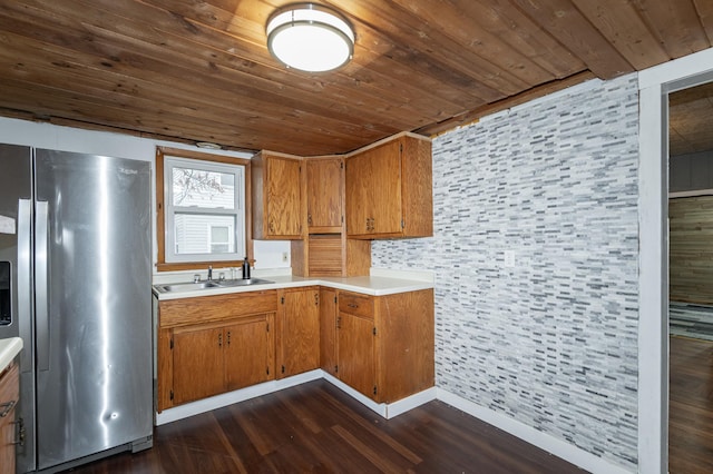 1210 9th St NE, Austin, MN 55912 - kitchen featuring stainless steel fridge with ice dispenser, wood ceiling, dark wood-style flooring, light countertops, and brown cabinetry