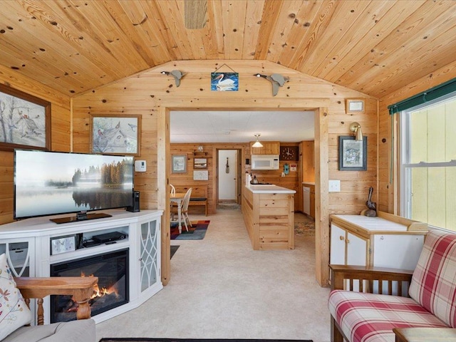 26713 Pelican Beach Rd, Lake Edward Twp, MN 56465 - living room with lofted ceiling, wood walls, wood ceiling, light carpet, and a glass covered fireplace