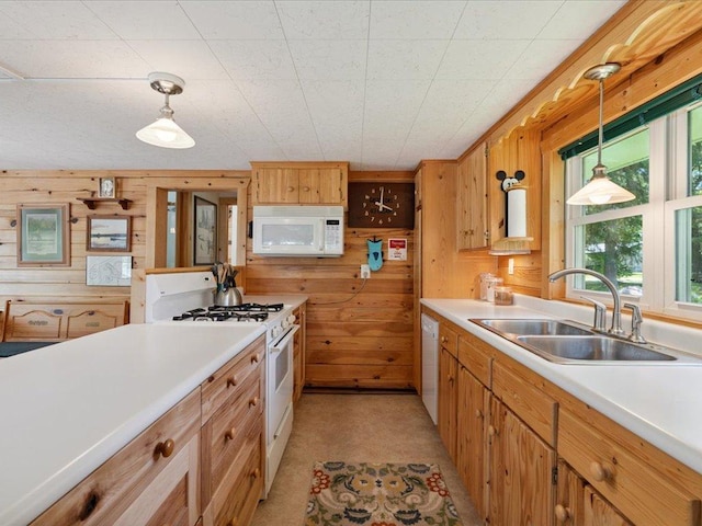 26713 Pelican Beach Rd, Lake Edward Twp, MN 56465 - kitchen with white appliances, wooden walls, light countertops, and pendant lighting