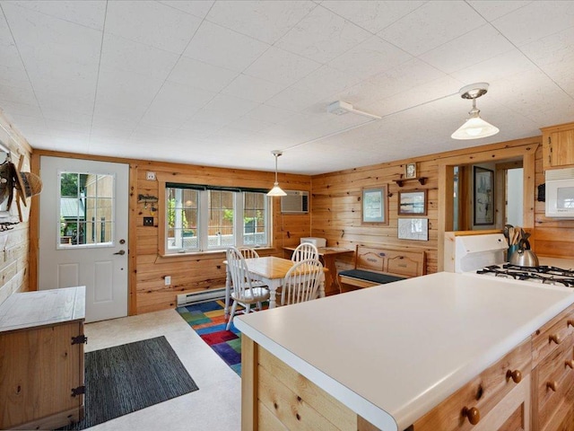 26713 Pelican Beach Rd, Lake Edward Twp, MN 56465 - kitchen with white appliances, wooden walls, pendant lighting, a wall mounted AC, and carpet