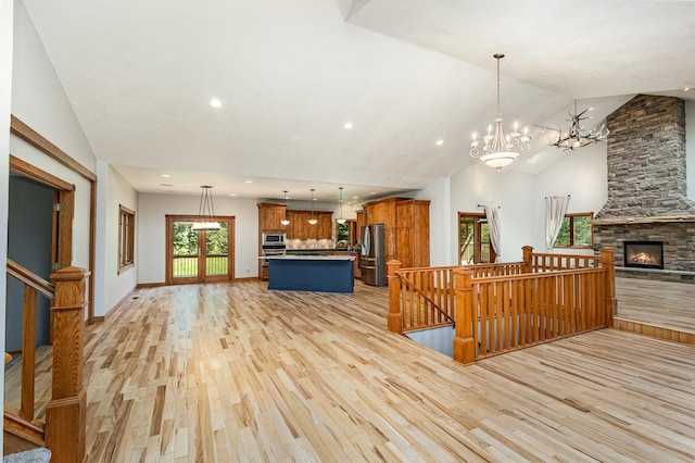 2655 88th Ct W, Northfield, MN 55057 - living room with light wood finished floors, plenty of natural light, lofted ceiling, recessed lighting, and a chandelier