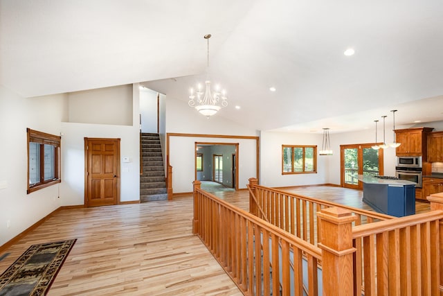 2655 88th Ct W, Northfield, MN 55057 - corridor featuring recessed lighting, light wood-style floors, a chandelier, high vaulted ceiling, and stairs