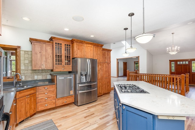 2655 88th Ct W, Northfield, MN 55057 - kitchen with stainless steel appliances, light wood-style flooring, decorative backsplash, pendant lighting, and vaulted ceiling
