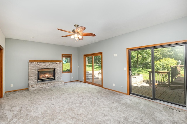 2655 88th Ct W, Northfield, MN 55057 - unfurnished living room with carpet, ceiling fan, and a brick fireplace