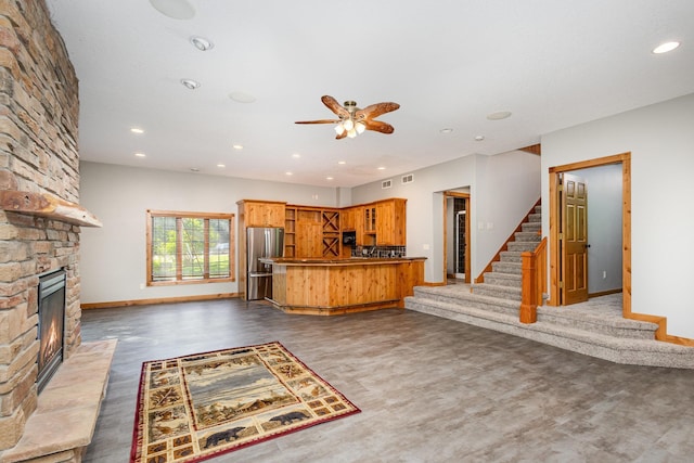 2655 88th Ct W, Northfield, MN 55057 - kitchen with freestanding refrigerator, open floor plan, a stone fireplace, a ceiling fan, and recessed lighting