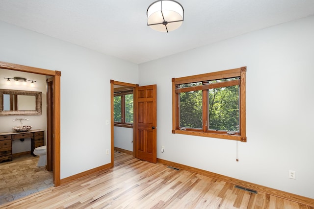 2655 88th Ct W, Northfield, MN 55057 - unfurnished bedroom featuring light wood-style flooring and connected bathroom
