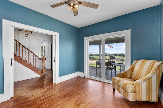 W2741 US Highway 10, Grant Twp, WI 54436 - sitting room with stairway, wood finished floors, and ceiling fan