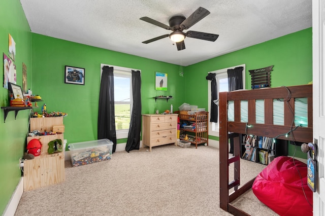 W2741 US Highway 10, Grant Twp, WI 54436 - carpeted bedroom featuring multiple windows, a textured ceiling, and a ceiling fan