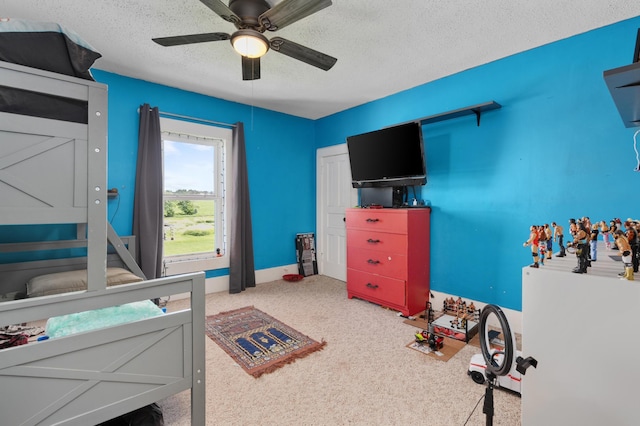 W2741 US Highway 10, Grant Twp, WI 54436 - carpeted bedroom with a textured ceiling and a ceiling fan