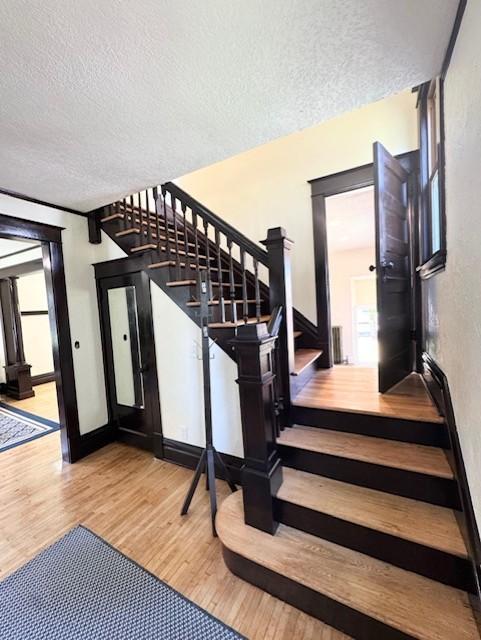 3124 Longfellow Ave, Minneapolis, MN 55407 - stairs featuring wood finished floors and a textured ceiling