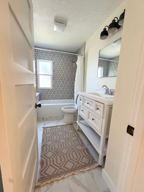 3124 Longfellow Ave, Minneapolis, MN 55407 - full bathroom featuring marble finish flooring, vanity, shower / bath combination with curtain, and a textured ceiling