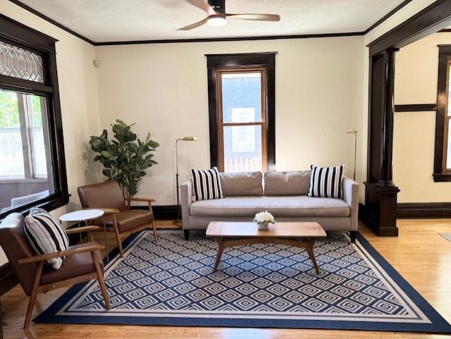 3124 Longfellow Ave, Minneapolis, MN 55407 - living area featuring wood finished floors, ornamental molding, a ceiling fan, and a textured ceiling