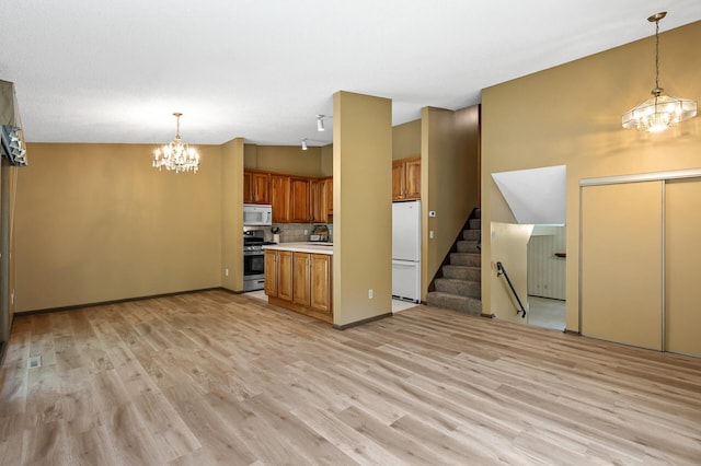 1010 Zanzibar Ln N, Plymouth, MN 55447 - kitchen with a chandelier, white appliances, brown cabinets, light countertops, and light wood-type flooring