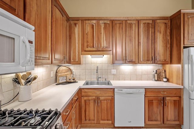 1010 Zanzibar Ln N, Plymouth, MN 55447 - kitchen with white appliances, brown cabinets, light countertops, and decorative backsplash