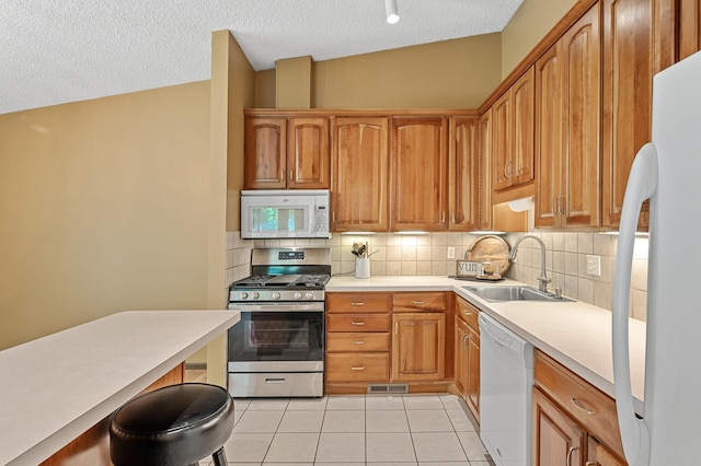 1010 Zanzibar Ln N, Plymouth, MN 55447 - kitchen with white appliances, light tile patterned floors, backsplash, a textured ceiling, and light countertops