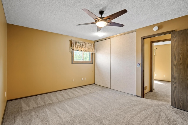 1010 Zanzibar Ln N, Plymouth, MN 55447 - unfurnished bedroom featuring carpet floors, a closet, a textured ceiling, and a ceiling fan