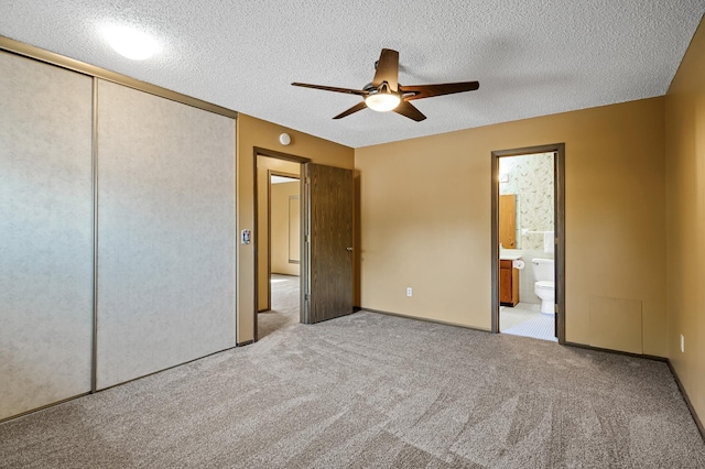 1010 Zanzibar Ln N, Plymouth, MN 55447 - unfurnished bedroom with carpet floors, ensuite bathroom, a closet, a textured ceiling, and ceiling fan