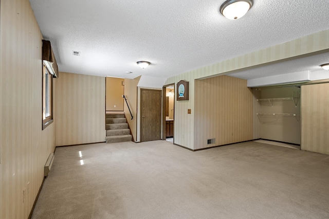 1010 Zanzibar Ln N, Plymouth, MN 55447 - finished basement featuring a textured ceiling, light carpet, wallpapered walls, stairs, and a baseboard heating unit