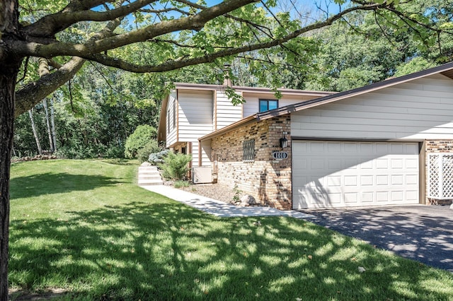 1010 Zanzibar Ln N, Plymouth, MN 55447 - view of side of property with brick siding, an attached garage, driveway, and a yard