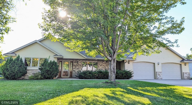 506 6th St SE, Little Falls, MN 56345 - obstructed view of property featuring a front yard, a garage, driveway, and brick siding