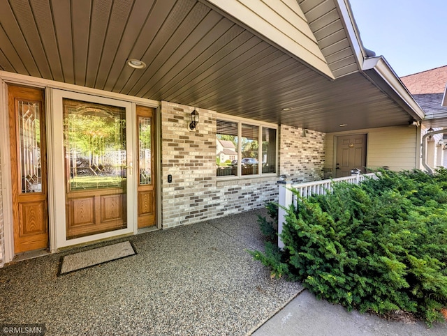 506 6th St SE, Little Falls, MN 56345 - view of exterior entry featuring a porch and brick siding
