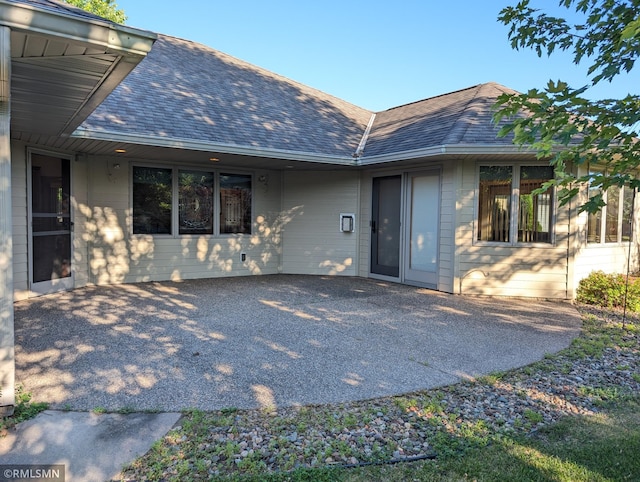 506 6th St SE, Little Falls, MN 56345 - rear view of house featuring a patio and roof with shingles