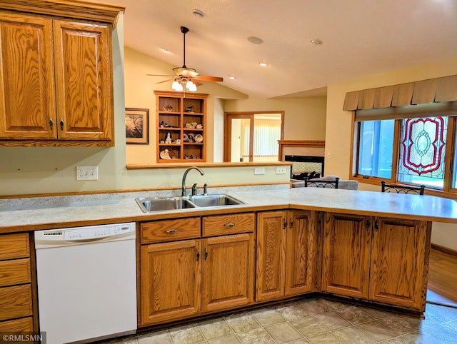 506 6th St SE, Little Falls, MN 56345 - kitchen with white dishwasher, a peninsula, light countertops, vaulted ceiling, and brown cabinetry