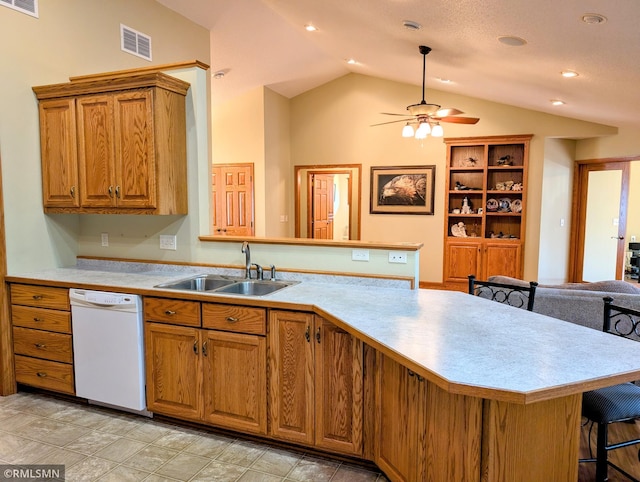 506 6th St SE, Little Falls, MN 56345 - kitchen with dishwasher, a peninsula, brown cabinetry, light countertops, and lofted ceiling