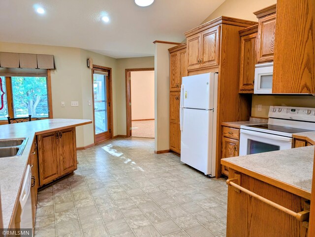 506 6th St SE, Little Falls, MN 56345 - kitchen featuring white appliances, light countertops, recessed lighting, and brown cabinetry