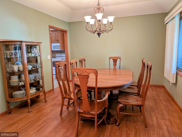 506 6th St SE, Little Falls, MN 56345 - dining room with a chandelier and light wood finished floors