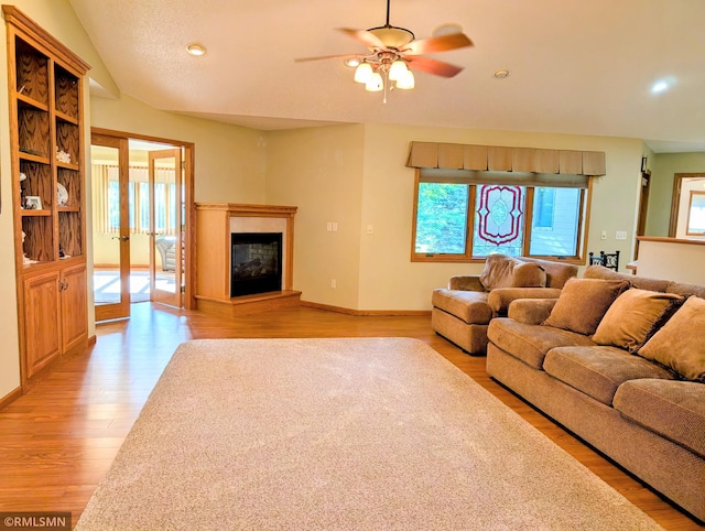 506 6th St SE, Little Falls, MN 56345 - living room with light wood-type flooring, a ceiling fan, a glass covered fireplace, and recessed lighting
