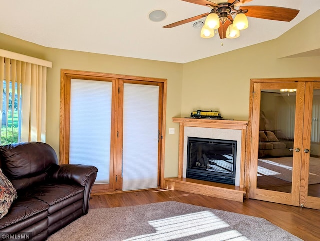506 6th St SE, Little Falls, MN 56345 - living room with a ceiling fan, wood finished floors, lofted ceiling, and a fireplace with raised hearth