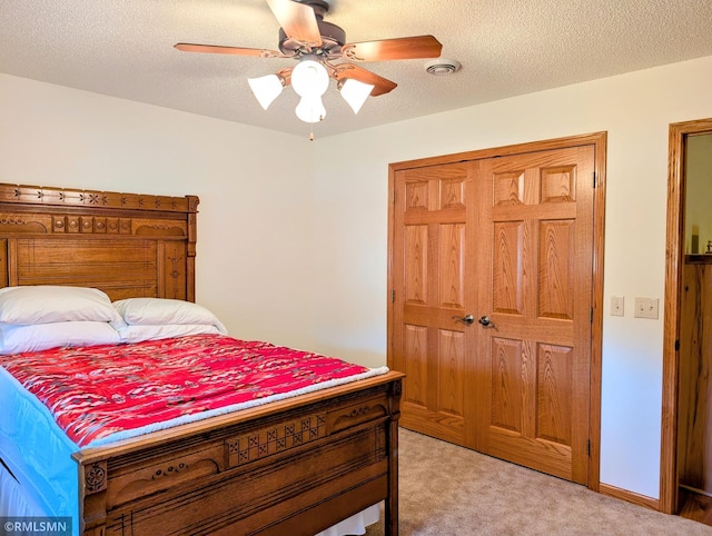506 6th St SE, Little Falls, MN 56345 - bedroom featuring light colored carpet, ceiling fan, a closet, and a textured ceiling