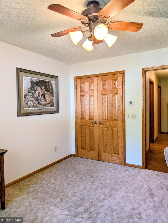 506 6th St SE, Little Falls, MN 56345 - carpeted bedroom featuring a textured ceiling, a ceiling fan, and a closet