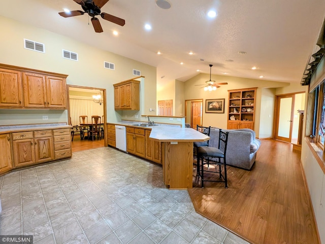 506 6th St SE, Little Falls, MN 56345 - kitchen featuring a ceiling fan, dishwasher, a peninsula, a kitchen breakfast bar, and recessed lighting