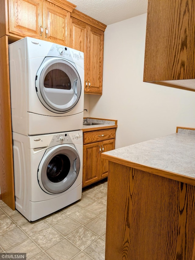 506 6th St SE, Little Falls, MN 56345 - washroom with stacked washing machine and dryer, cabinet space, and a textured ceiling