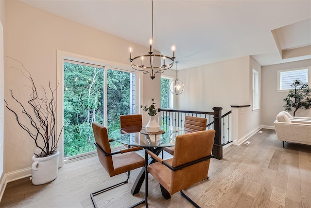 7396 Agate Trl, Inver Grove Heights, MN 55077 - dining area featuring a chandelier and light wood-type flooring