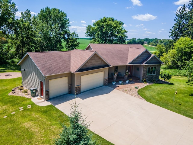 1322 Frontier Rd SE, Salem Twp, MN 55920 - craftsman inspired home featuring stone siding, an attached garage, concrete driveway, and a front yard